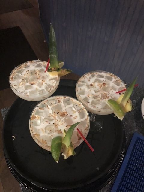 Three coconut margaritas with toasted coconut