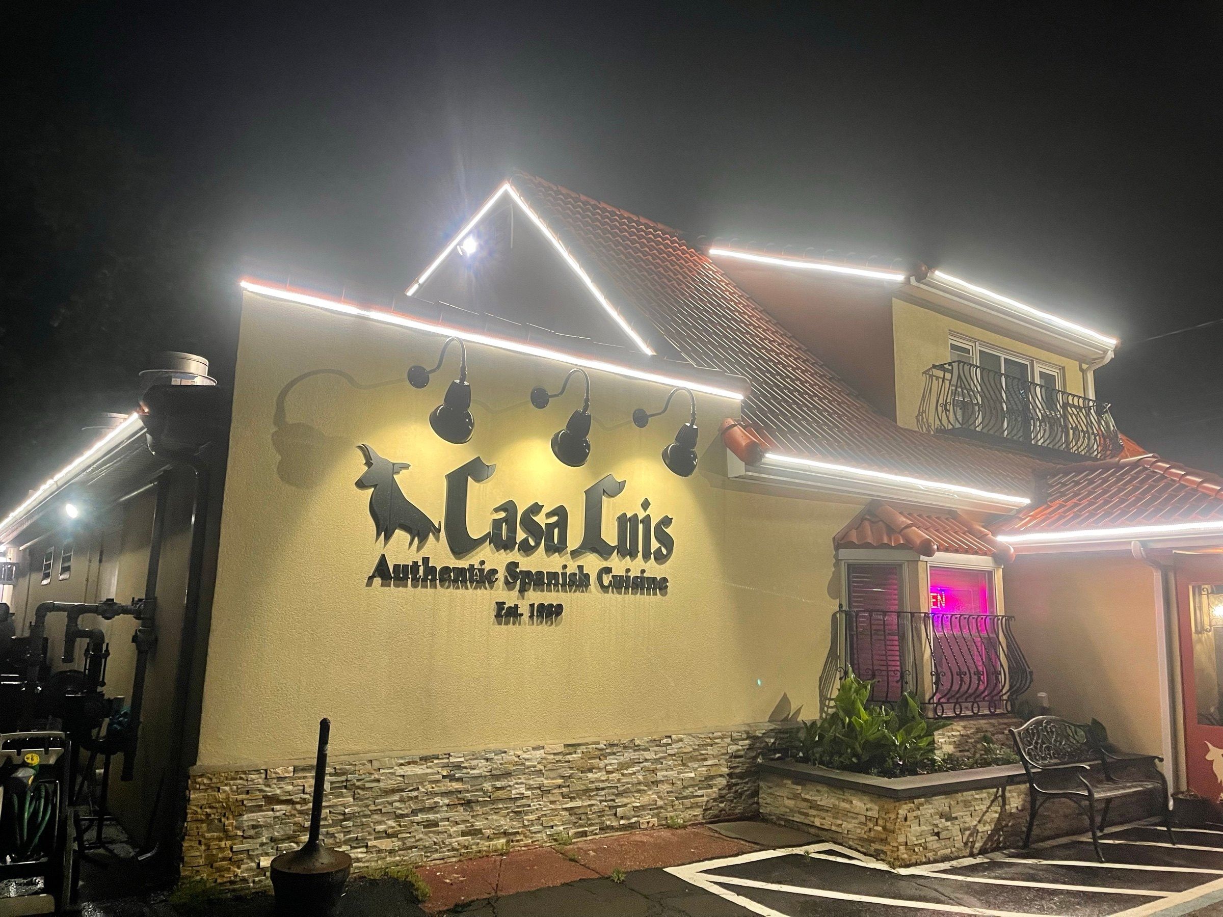 Casa Luis at night, its “Authentic Spanish Cuisine, Est. 1989” sign lit up