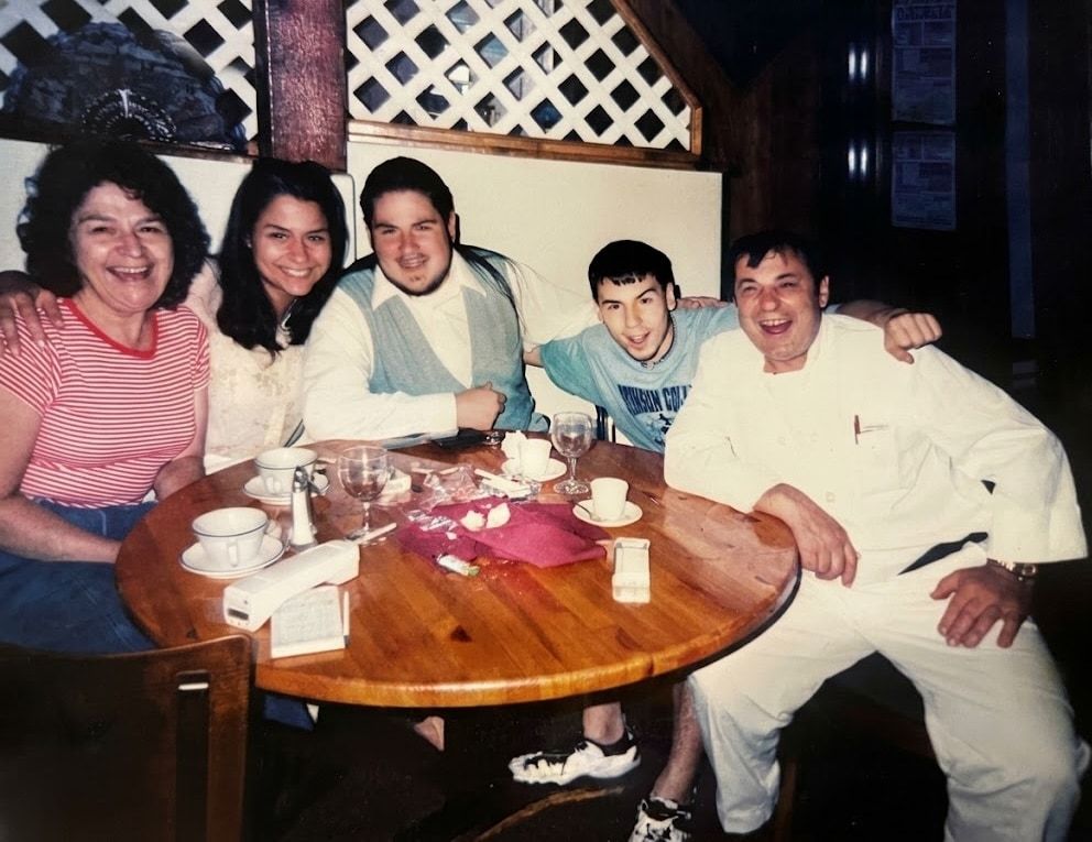 An old family photo: Carmen, Luis in his chef’s whites, and their children Delia, Luis and Antonio around a table