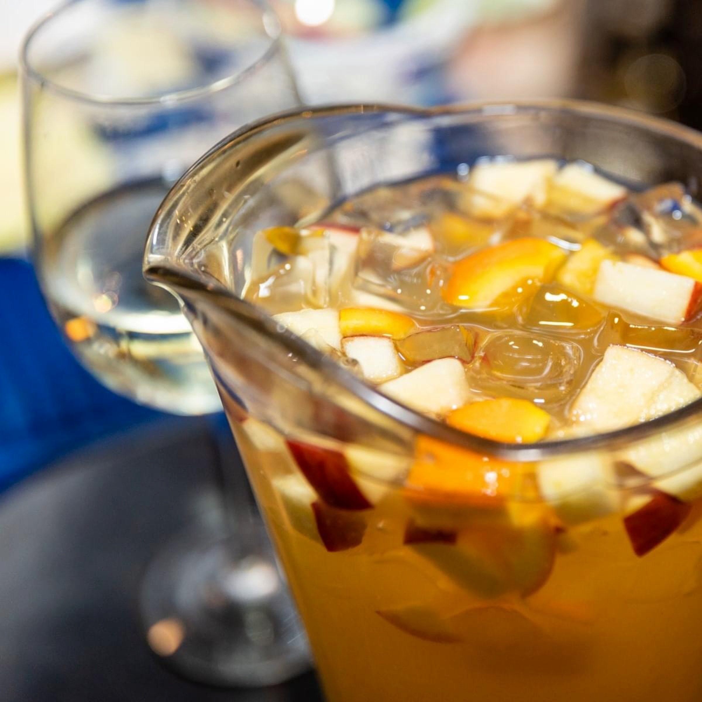 A pitcher of sangria full of fruit