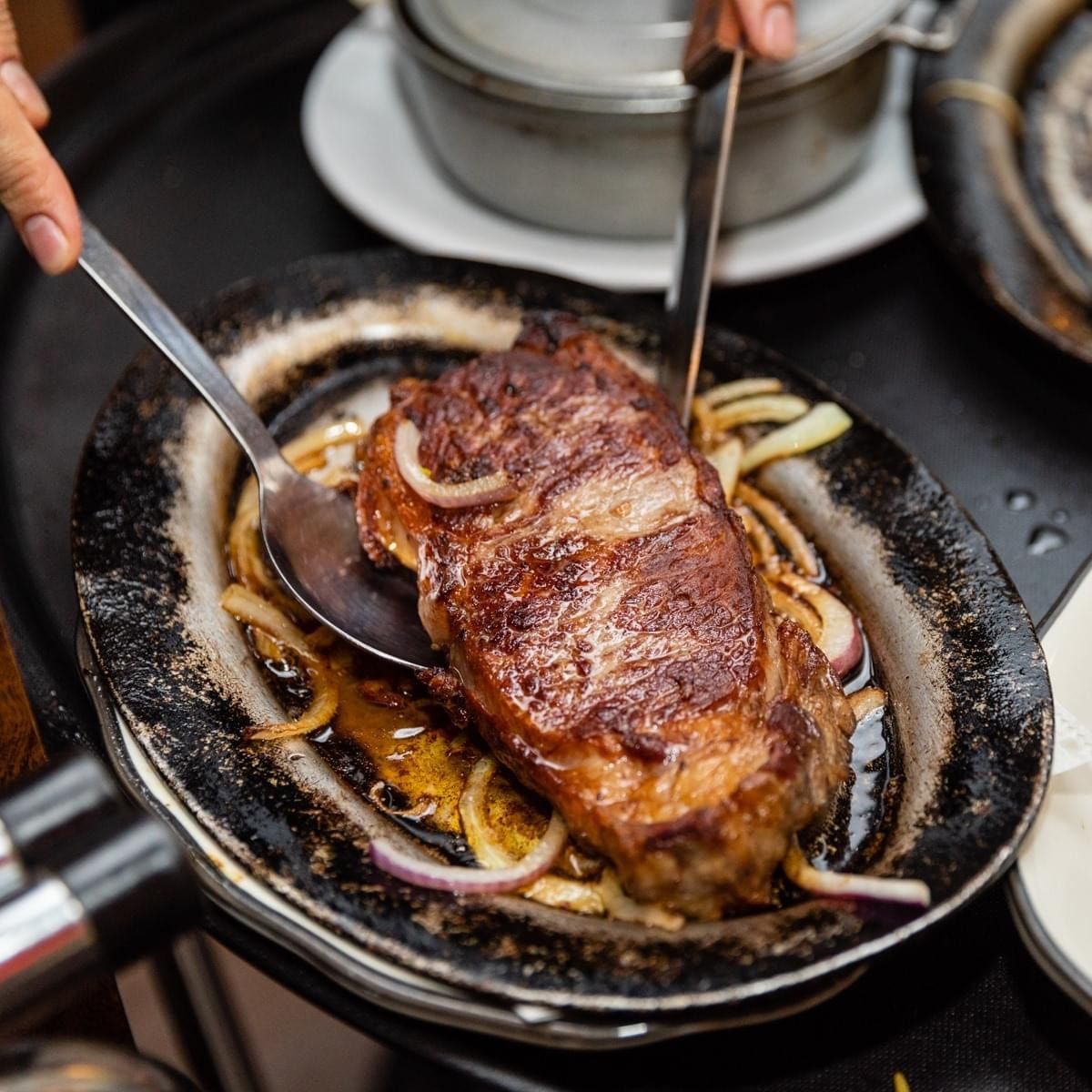 Sizzling sirloin steak with onions